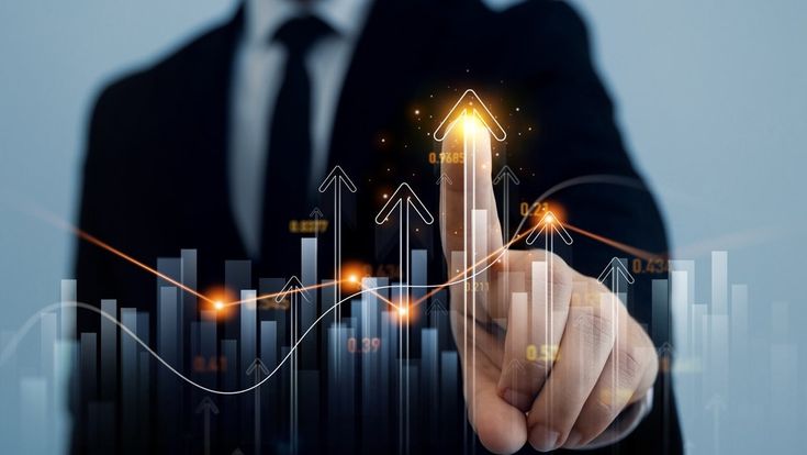 Homem de terno apontando para gráficos digitais em crescimento, simbolizando o avanço dos investimentos e ilustrando o que é renda fixa e renda variável no mercado financeiro.